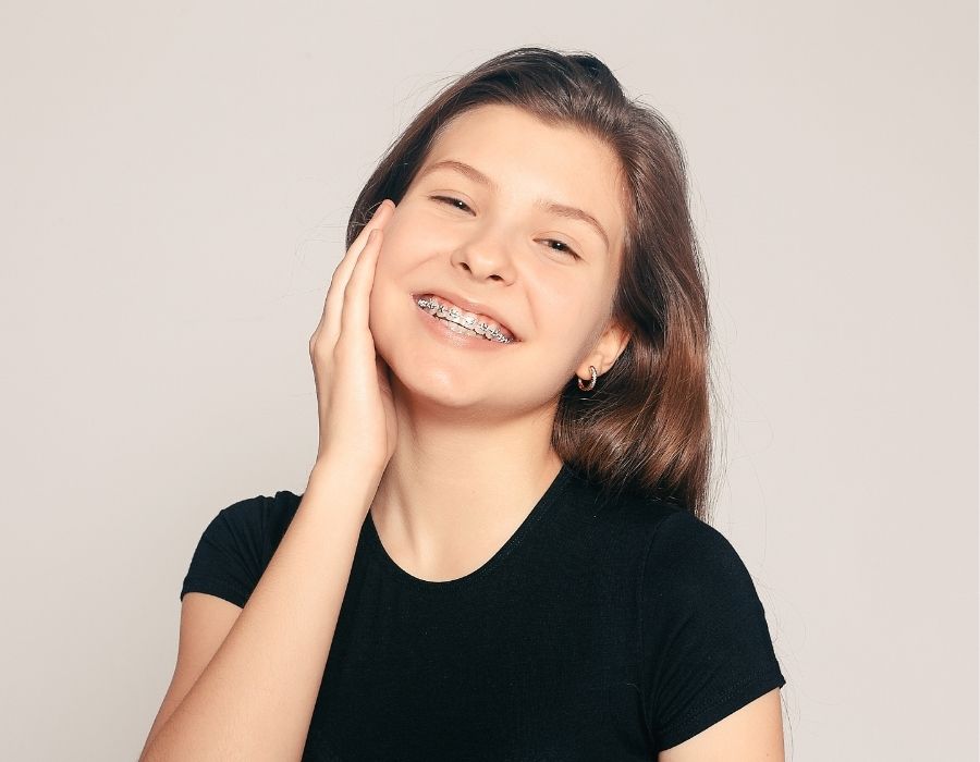 a girl smiling beautifully with braces