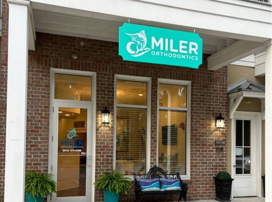 Front entrance of Miler Orthodontics office with sign and welcoming seating area
