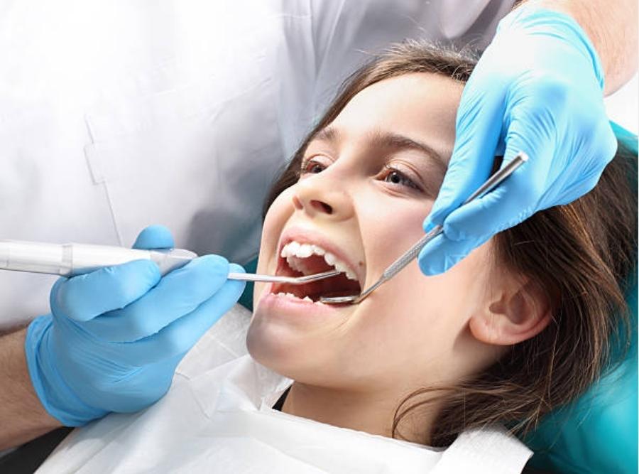orthodontist performing treatment on a child