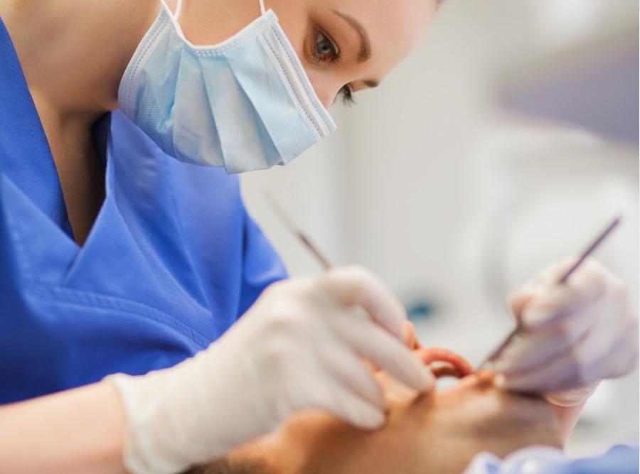 orthodontist checking adult's teeth